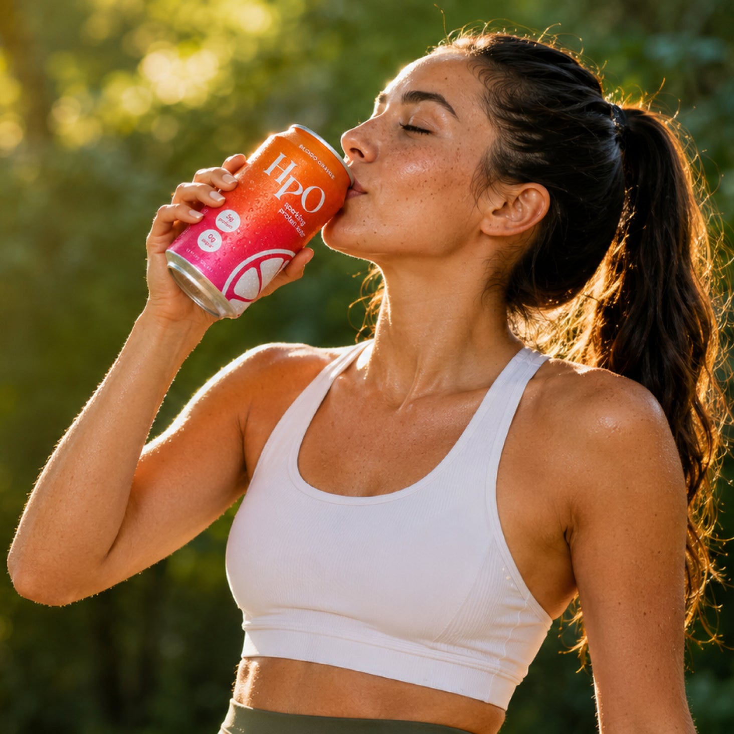 A woman enjoying HpO sparkling protein water